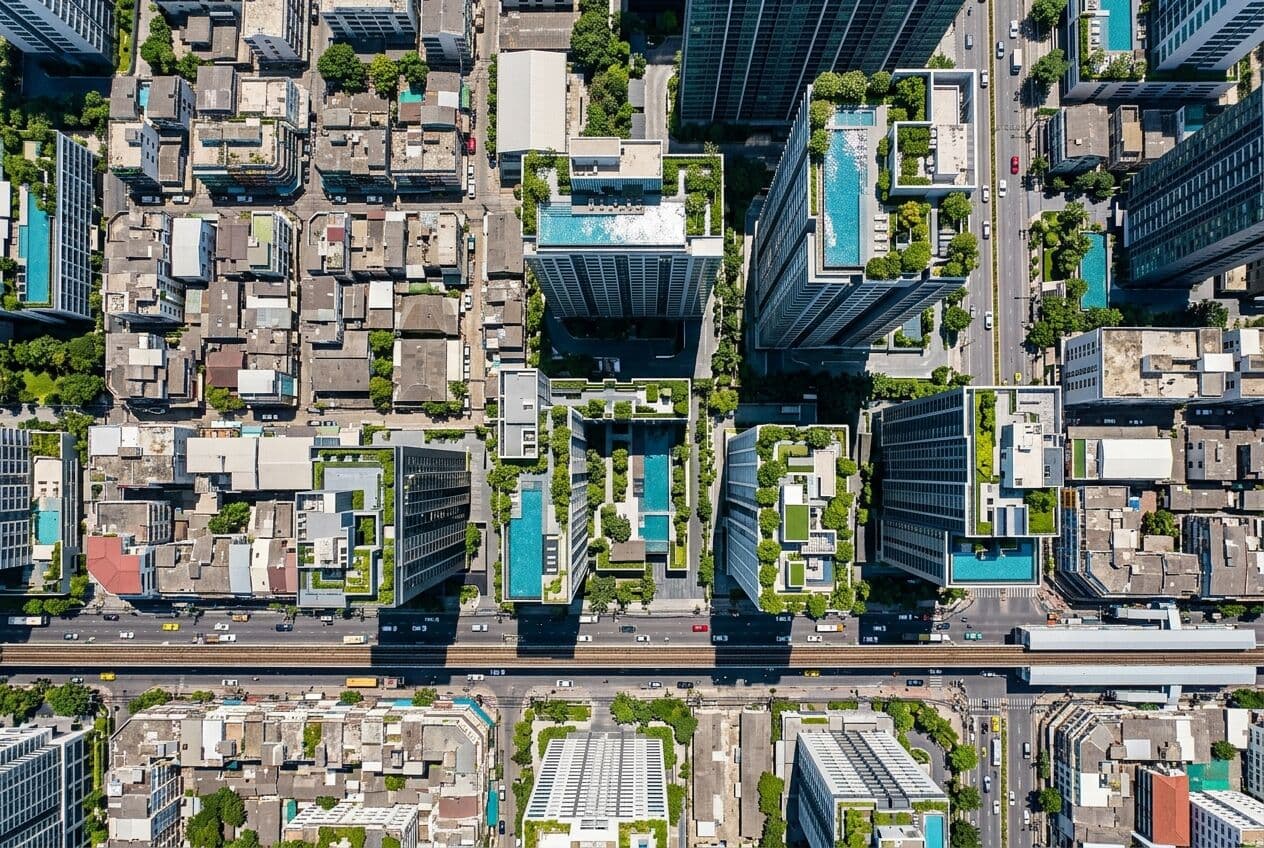 Aerial view of condominium towers with rooftop pools in Bangkok