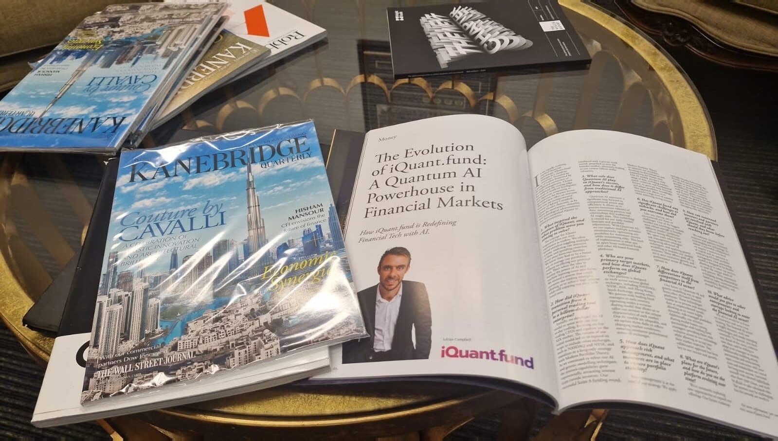 Copies of Kanebridge Quarterly on a table, one open at the iQuant.fund feature with Adrian Campbell's photo